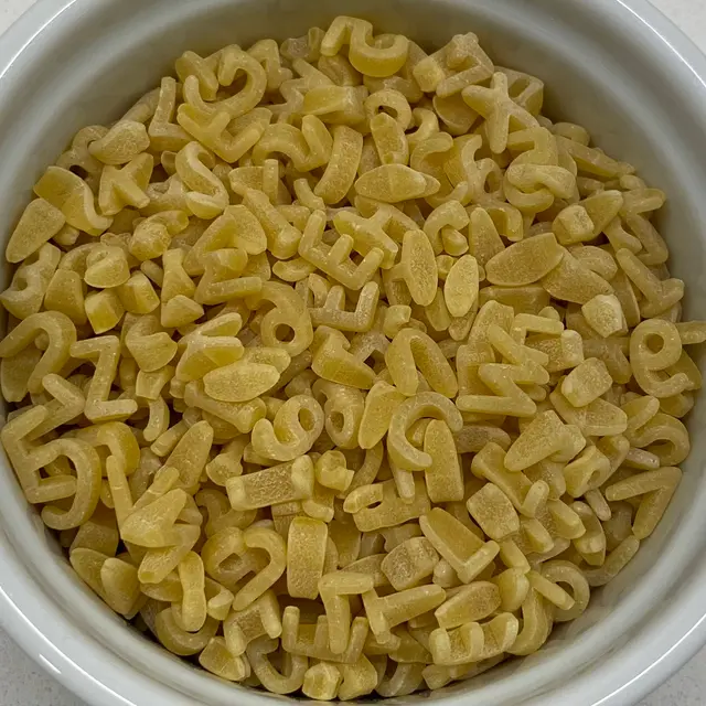 A close up shot of Alphabet in a round white ramekin