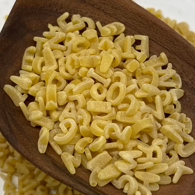 A close up shot of Alphabet in a wooden serving spoon