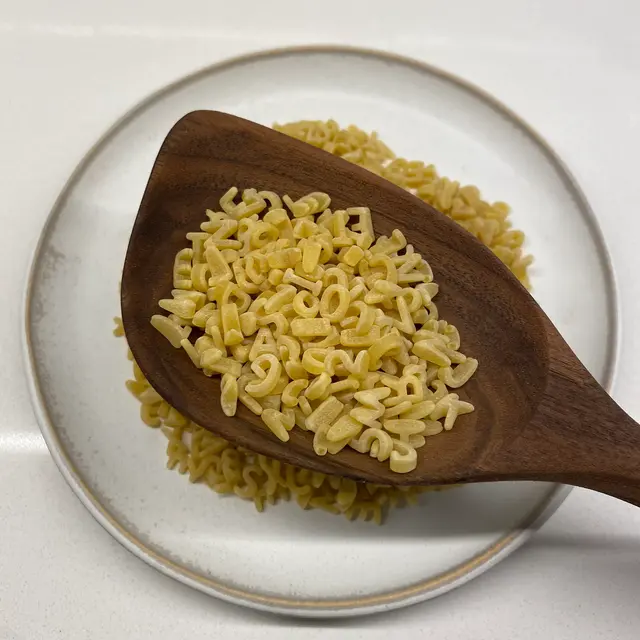 Alphabet in a wooden serving spoon