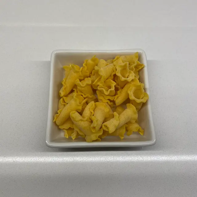 Campanelle in a square white glass bowl