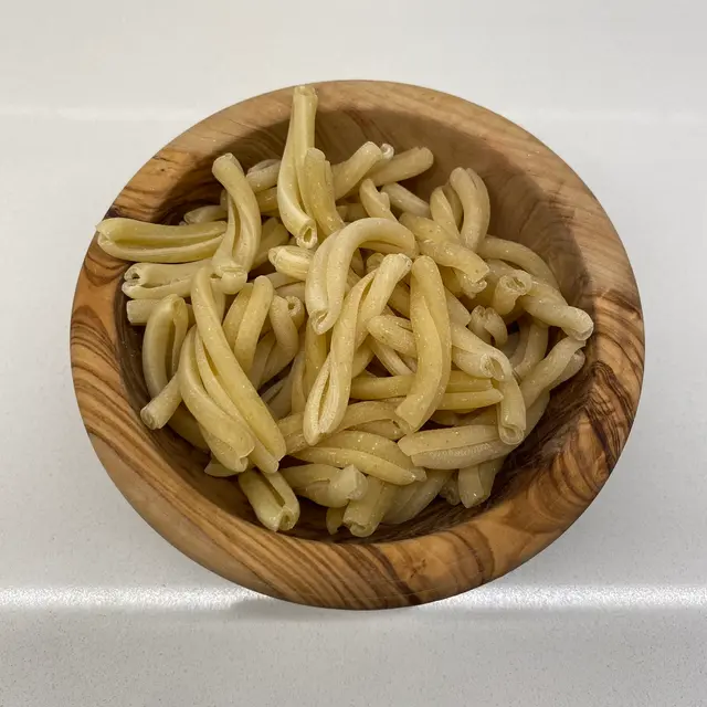 Casarecce in a round wooden bowl