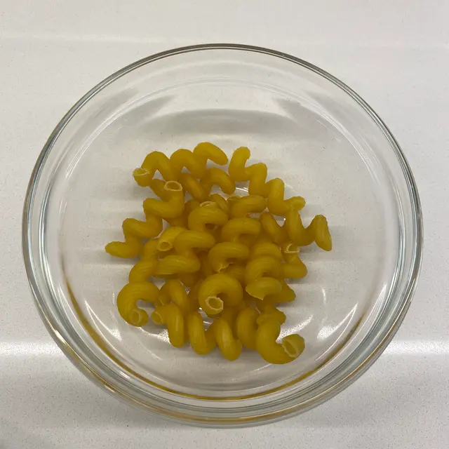 Cavatappi in a clear round glass bowl