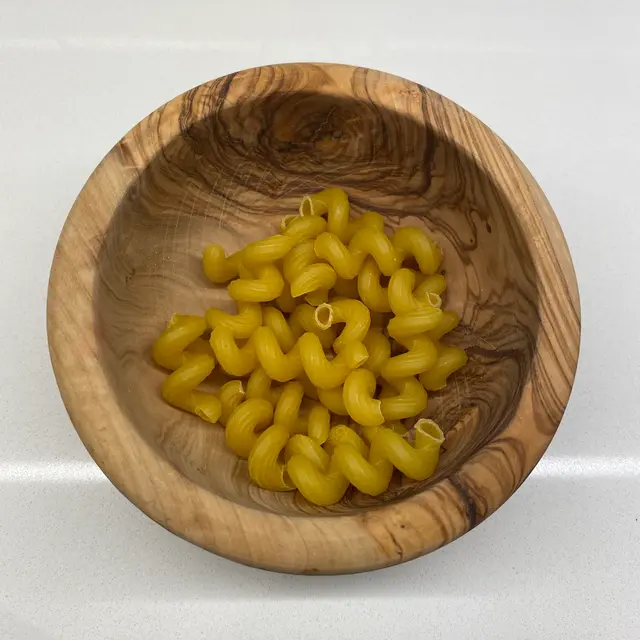 Cavatappi in a round wooden bowl