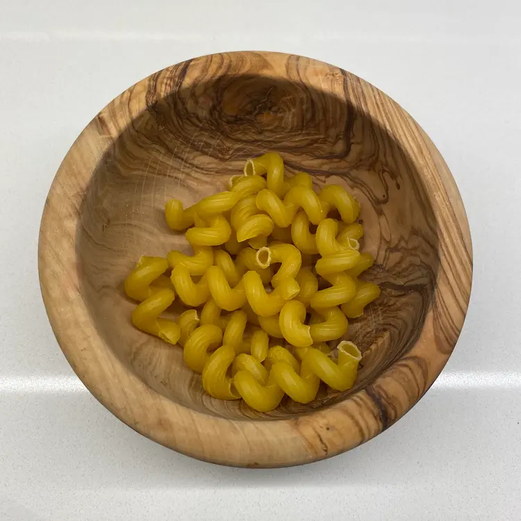 Cavatappi in a round wooden bowl