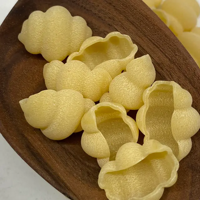 A close up shot of Cestini in a wooden serving spoon