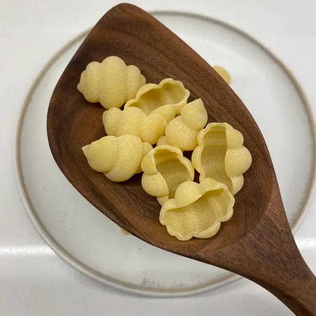 Cestini in a wooden serving spoon