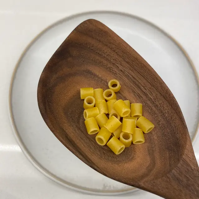 Ditalini in a wooden serving spoon