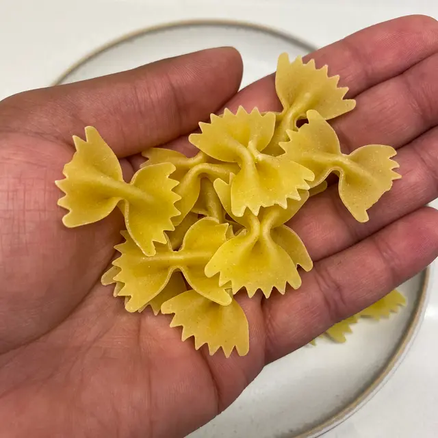 Farfalle in a hand