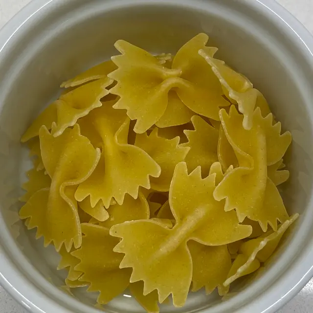 A close up shot of Farfalle in a round white ramekin