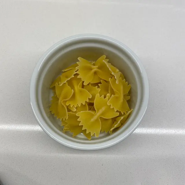 Farfalle in a round white ramekin