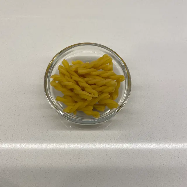 Gemelli in a small round white glass bowl