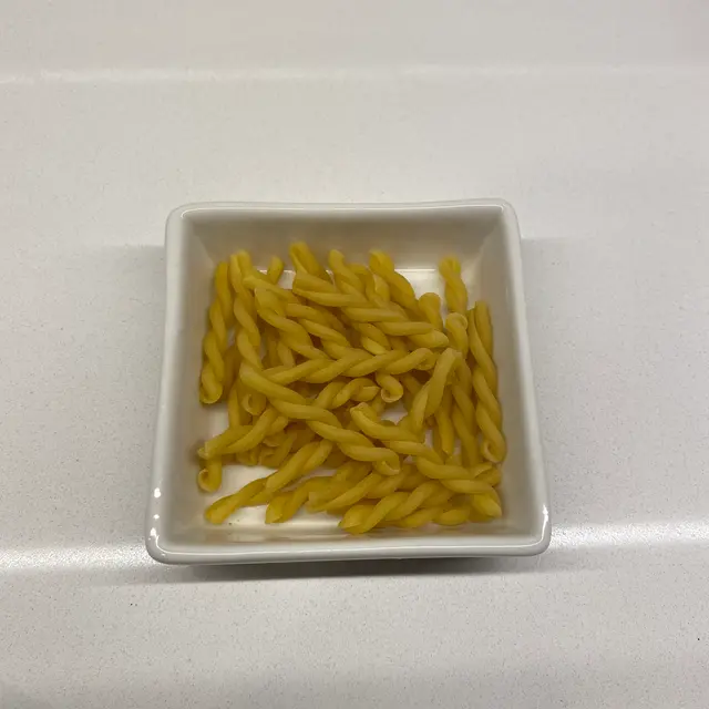 Gemelli in a square white glass bowl