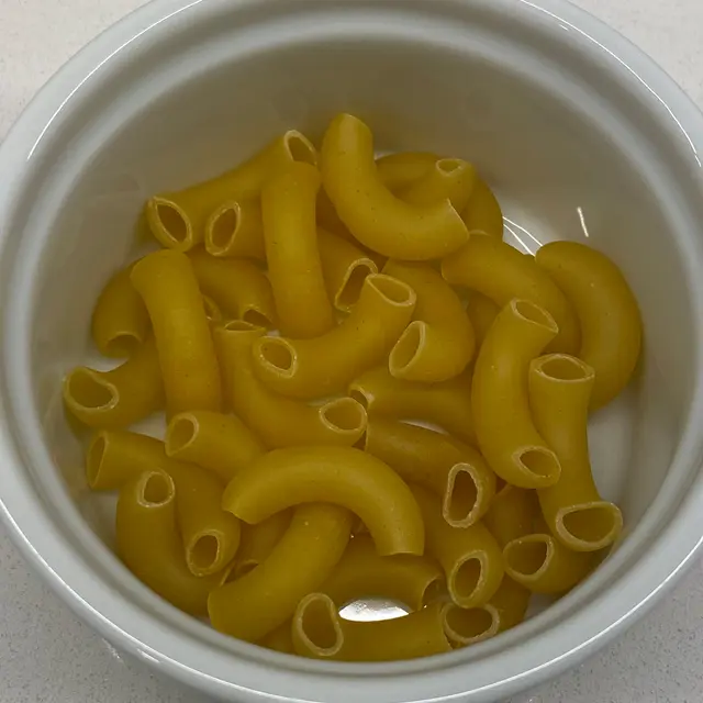 A close up shot of Large Elbow Macaroni in a round white ramekin