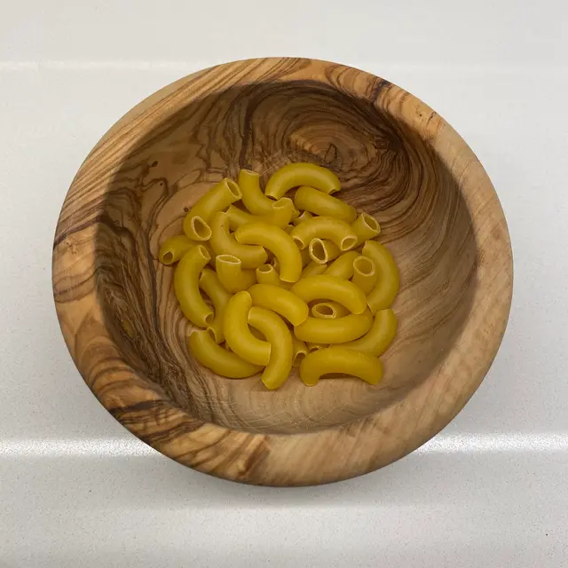 Large Elbow Macaroni in a round wooden bowl