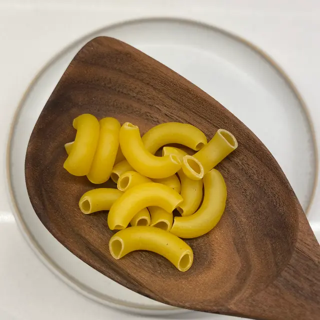 Large Elbow Macaroni in a wooden serving spoon