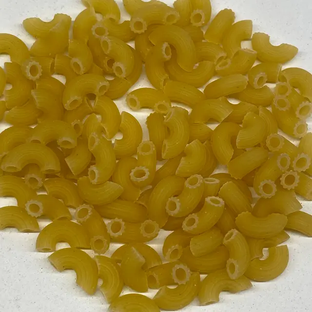 A close up shot of Small Elbow Macaroni on a white kitchen counter