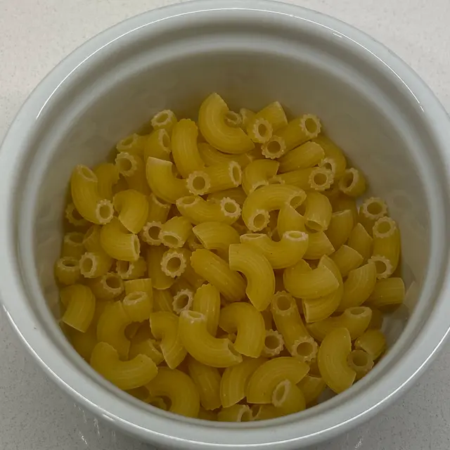 A close up shot of Small Elbow Macaroni in a round white ramekin