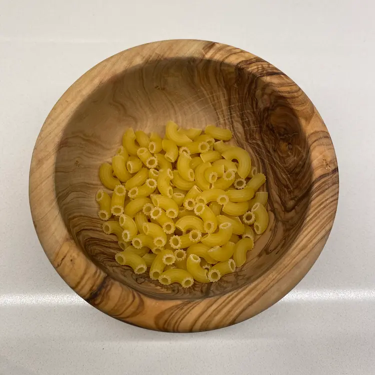 Small Elbow Macaroni in a round wooden bowl