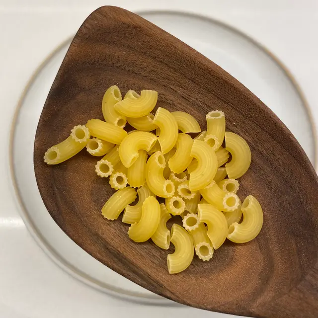 Small Elbow Macaroni in a wooden serving spoon