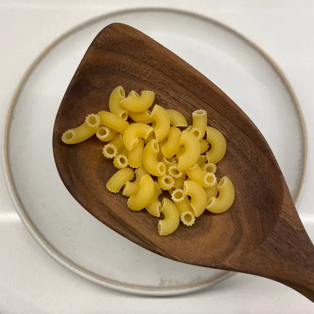 Small Elbow Macaroni in a wooden serving spoon