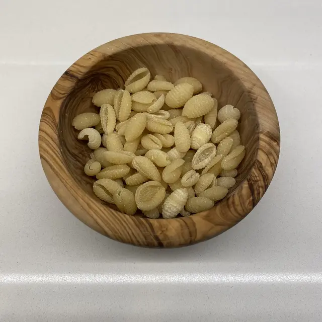 Malloreddus in a round wooden bowl