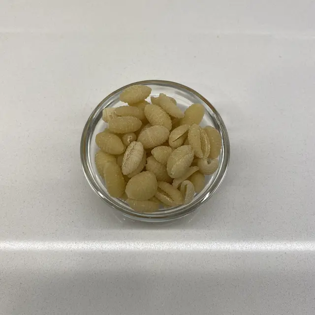 Malloreddus in a small round white glass bowl