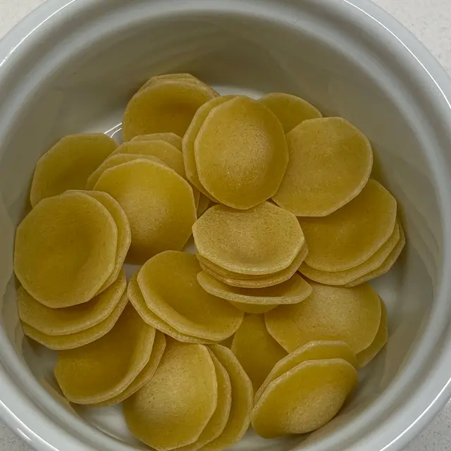 A close up shot of Orecchiette in a round white ramekin