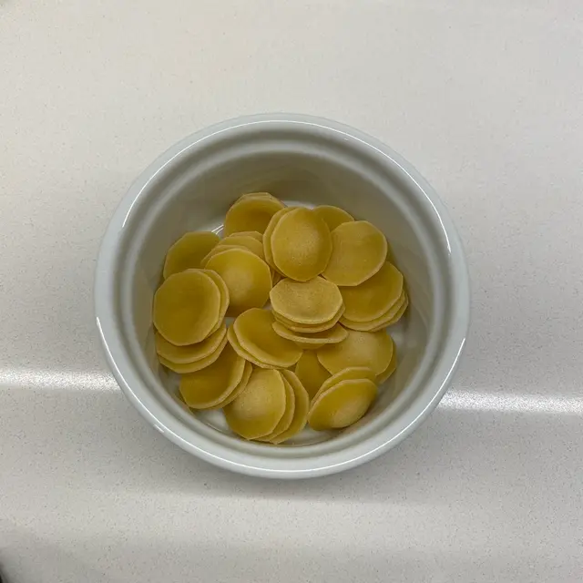 Orecchiette in a round white ramekin