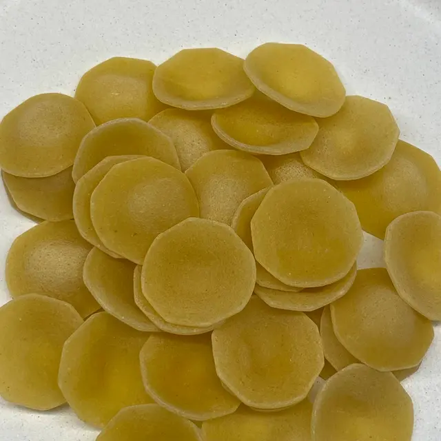 A close up shot of Orecchiette on a round white plate