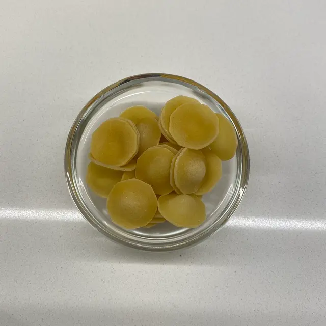 Orecchiette in a small round white glass bowl