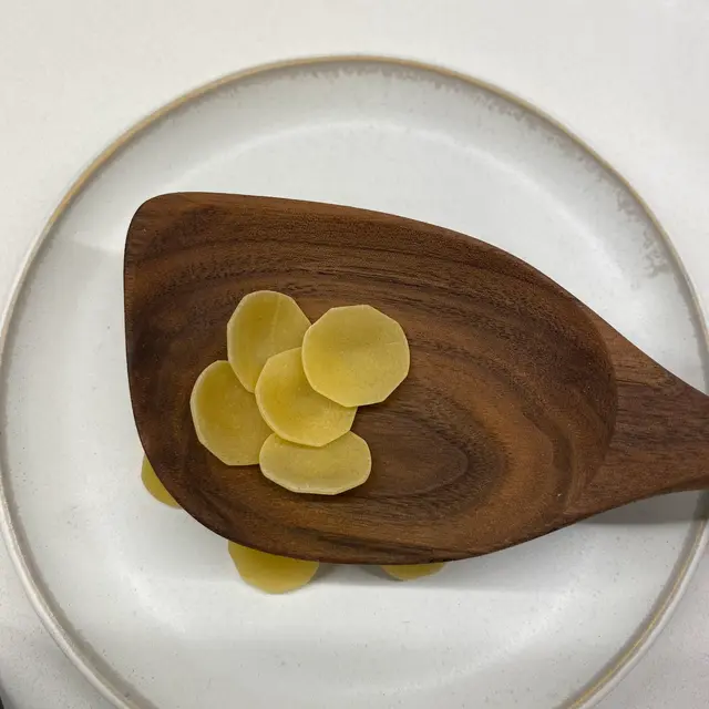 Orecchiette in a wooden serving spoon