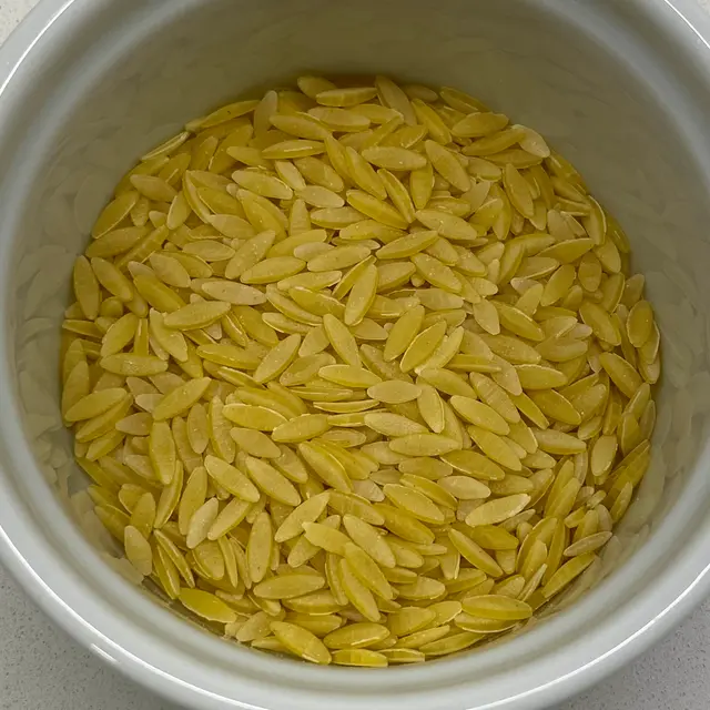 A close up shot of Orzo in a round white ramekin