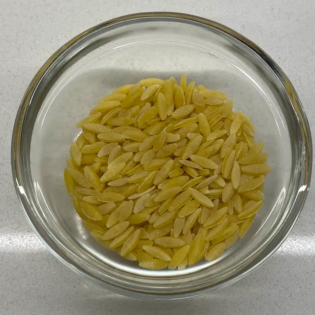 Orzo in a small round white glass bowl