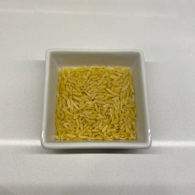 Orzo in a square white glass bowl