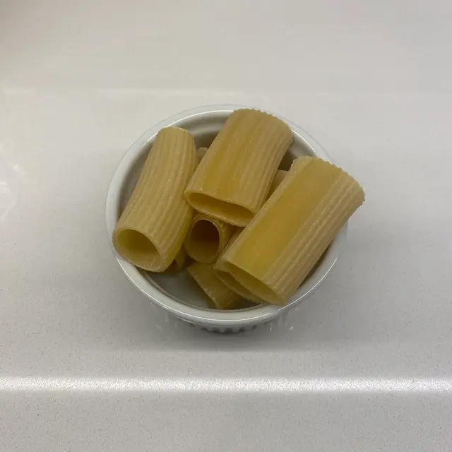 Paccheri in a round white ramekin