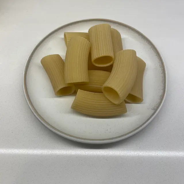 Paccheri on a round white plate