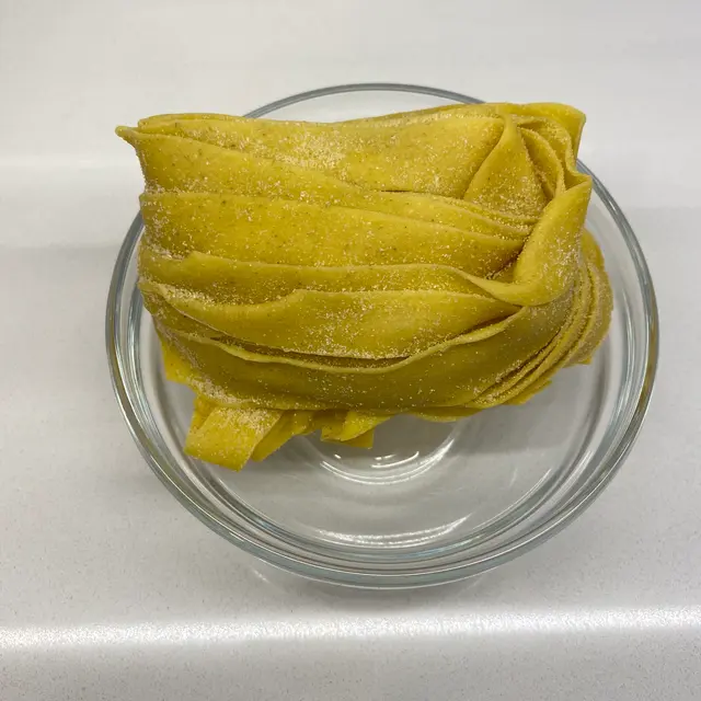 Pappardelle in a clear round glass bowl