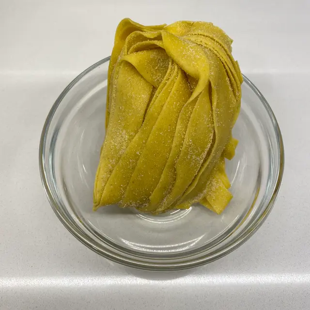 Pappardelle in a clear round glass bowl