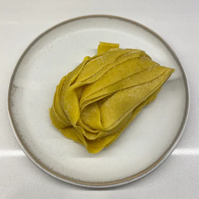 Pappardelle on a round white plate