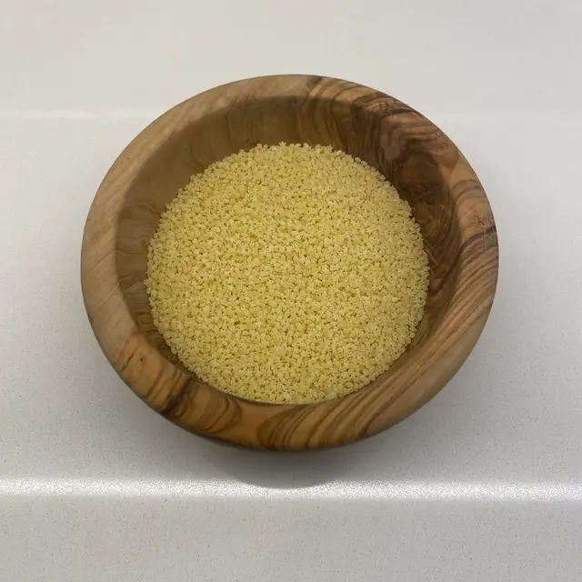 Pastina in a round wooden bowl