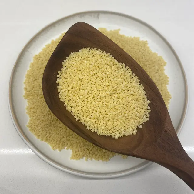 Pastina in a wooden serving spoon