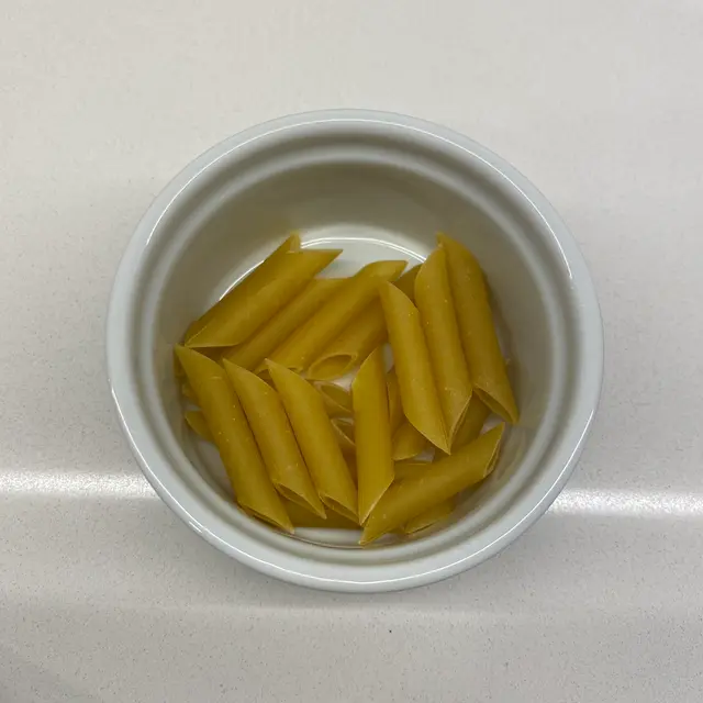 Penne in a round white ramekin