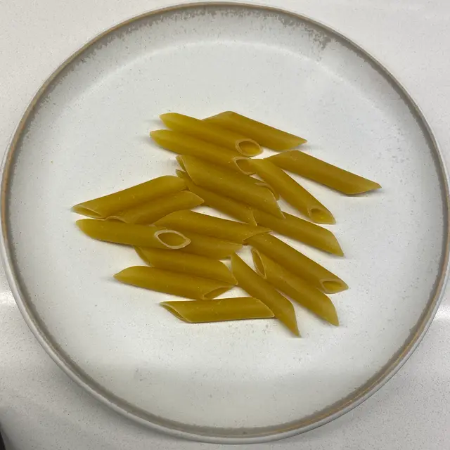 Penne on a round white plate