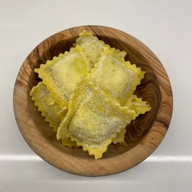 Ravioli in a round wooden bowl