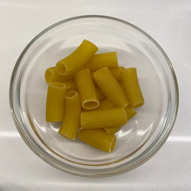 Rigatoni in a clear round glass bowl