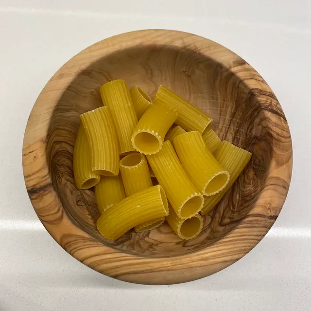 Rigatoni in a round wooden bowl