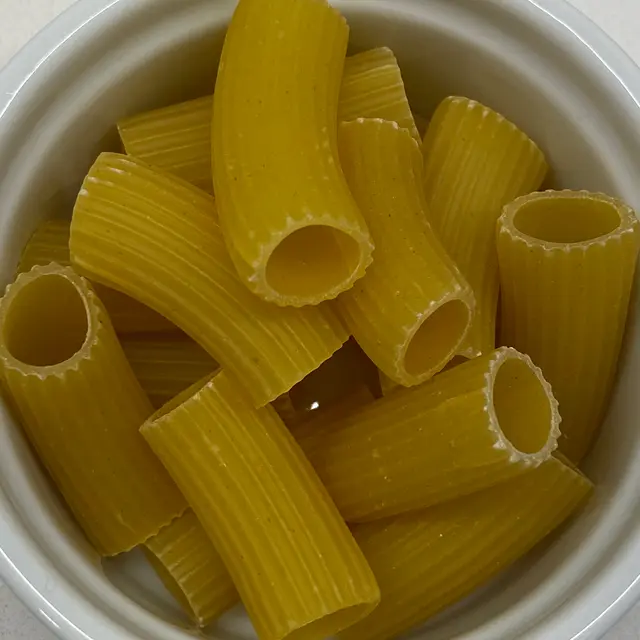 Rigatoni in a small white bowl