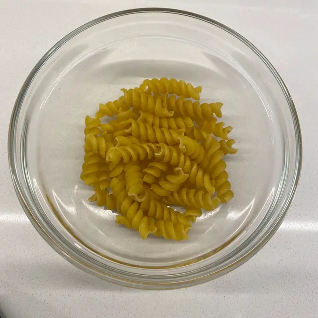 Rotini in a clear round glass bowl