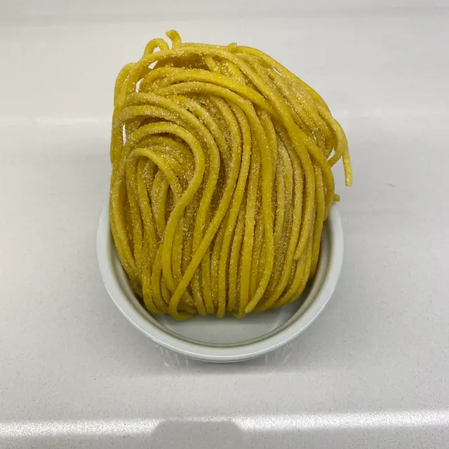 Spaghetti in a round white ramekin