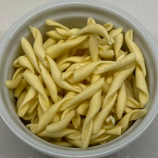 A close up shot of Strozzapreti in a round white ramekin